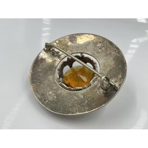 1114 - A Scottish white metal and faux citrine plaid pin brooch - approx. 8cm diameter and gross weight 108... 