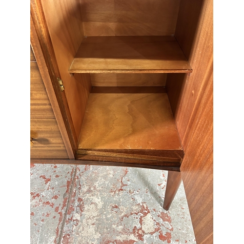 1 - A 1950s Gimson & Slater Ltd Vesper Furniture walnut sideboard with three central drawers and two out... 