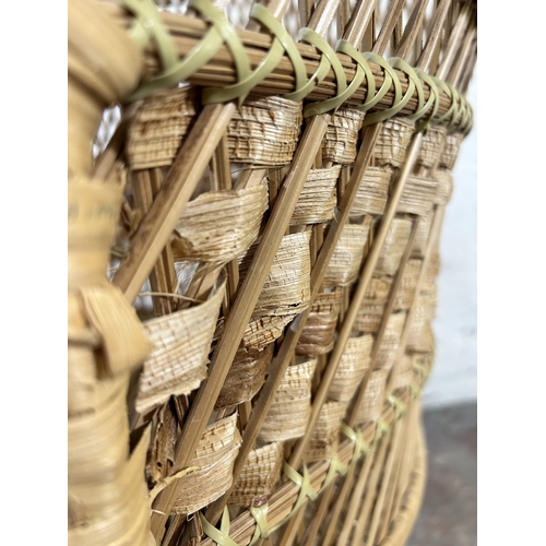 100 - A mid 20th century wicker peacock chair - approx. 108cm high x 68cm wide