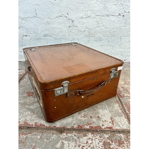 104 - A 1940s Rev-Robe brown leather suitcase retailed by Finnigans Deansgate Manchester - approx. 24cm hi... 