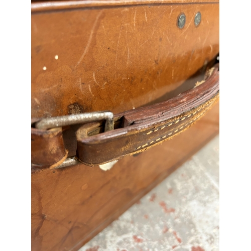 104 - A 1940s Rev-Robe brown leather suitcase retailed by Finnigans Deansgate Manchester - approx. 24cm hi... 