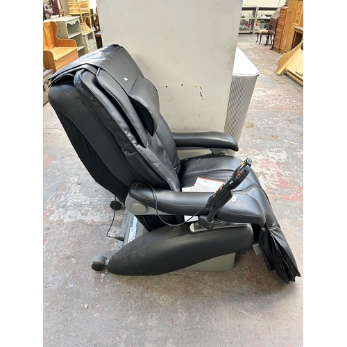 111 - An Inada W.1 black leatherette massage chair with operating manual and remote control