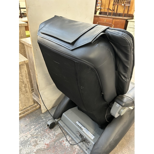 111 - An Inada W.1 black leatherette massage chair with operating manual and remote control