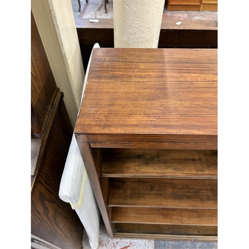 125 - A mid 20th century stained pine four tier bookcase with glass sliding doors and cabriole supports - ... 