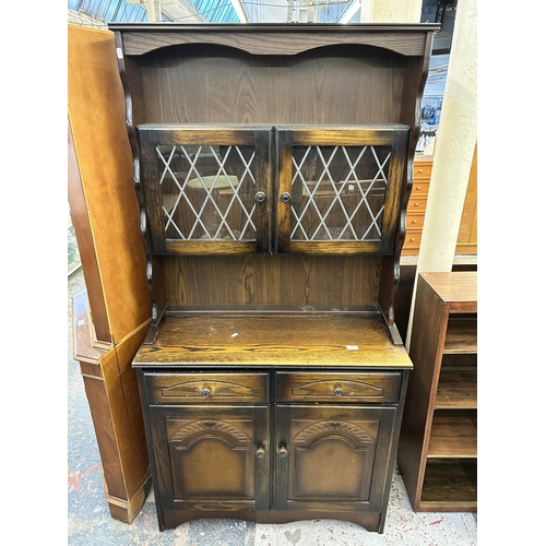 126 - An oak dresser with two upper leaded glass doors, two drawers and two lower cupboard doors - approx.... 