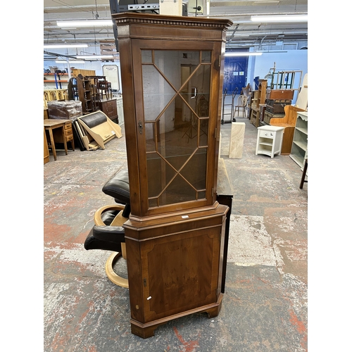 127 - A George III style yew wood freestanding corner cabinet - approx. 181cm high