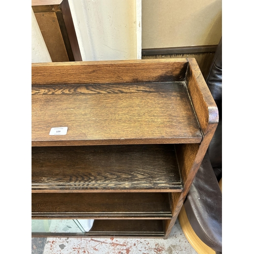 129 - A mid 20th century oak four tier bookcase with six glass sliding doors - approx. 92cm high x 91cm wi... 