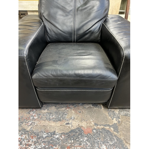 132 - A Soflex black leather armchair - approx. 90cm high x 111cm wide x 98cm deep