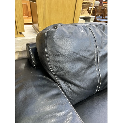 132 - A Soflex black leather armchair - approx. 90cm high x 111cm wide x 98cm deep