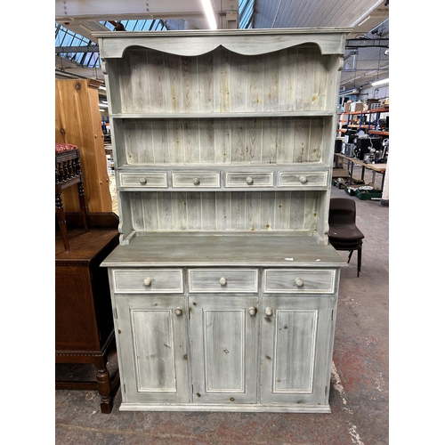 138 - A modern painted pine dresser with upper two tier plate rack, four short drawers, three long drawers... 