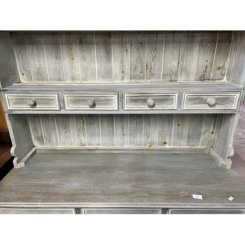 138 - A modern painted pine dresser with upper two tier plate rack, four short drawers, three long drawers... 