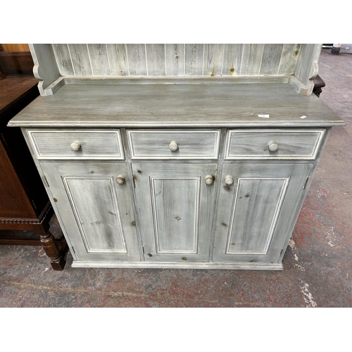 138 - A modern painted pine dresser with upper two tier plate rack, four short drawers, three long drawers... 