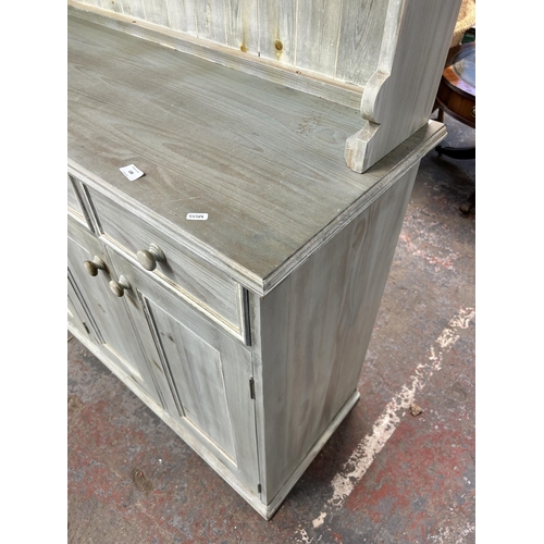 138 - A modern painted pine dresser with upper two tier plate rack, four short drawers, three long drawers... 