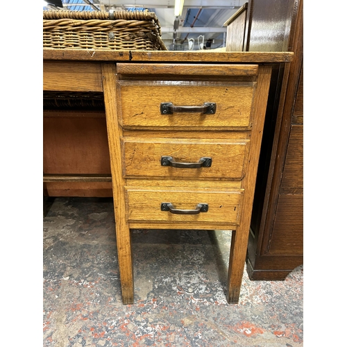 144 - A mid 20th century oak office desk with three drawers - approx. 71.5cm high x 91cm wide x 61cm deep