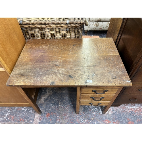 144 - A mid 20th century oak office desk with three drawers - approx. 71.5cm high x 91cm wide x 61cm deep