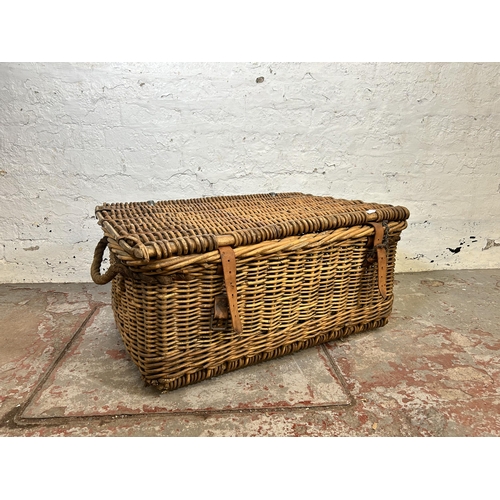 153 - A large wicker basket with two rope handles - approx. 34cm high x 80cm wide x 55cm deep