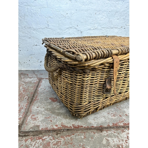 153 - A large wicker basket with two rope handles - approx. 34cm high x 80cm wide x 55cm deep