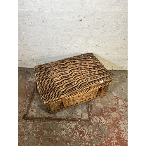 153 - A large wicker basket with two rope handles - approx. 34cm high x 80cm wide x 55cm deep