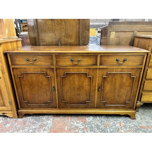 156 - A George III style yew wood sideboard with drawers and three cupboard doors - approx. 80cm high x 13... 