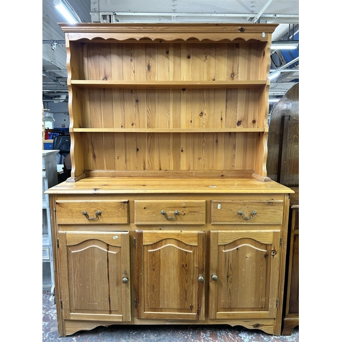 157 - A Victorian style pine Welsh dresser with upper two tier plate rack, three drawers and three cupboar... 