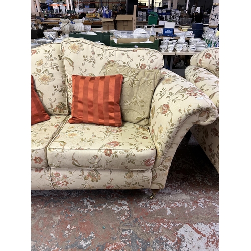 160A - A Regency style floral upholstered two seater sofa with mahogany supports and brass castors - approx... 