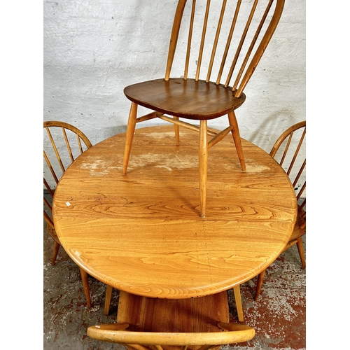 18 - An Ercol Windsor 384 blonde elm and beech drop leaf oval dining table and four Ercol Windsor dining ... 