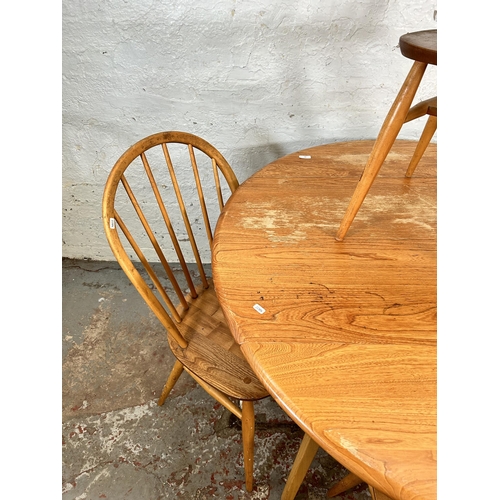 18 - An Ercol Windsor 384 blonde elm and beech drop leaf oval dining table and four Ercol Windsor dining ... 