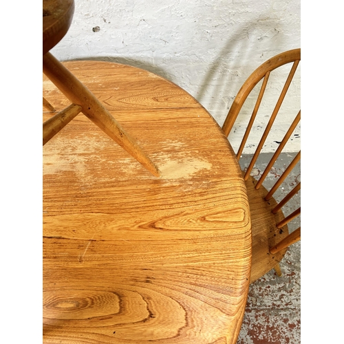 18 - An Ercol Windsor 384 blonde elm and beech drop leaf oval dining table and four Ercol Windsor dining ... 