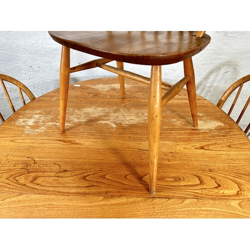 18 - An Ercol Windsor 384 blonde elm and beech drop leaf oval dining table and four Ercol Windsor dining ... 