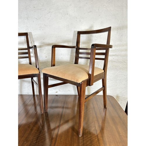 3 - A mid 20th century walnut extending dining table and six matching chairs - approx. 75cm high x 86cm ... 