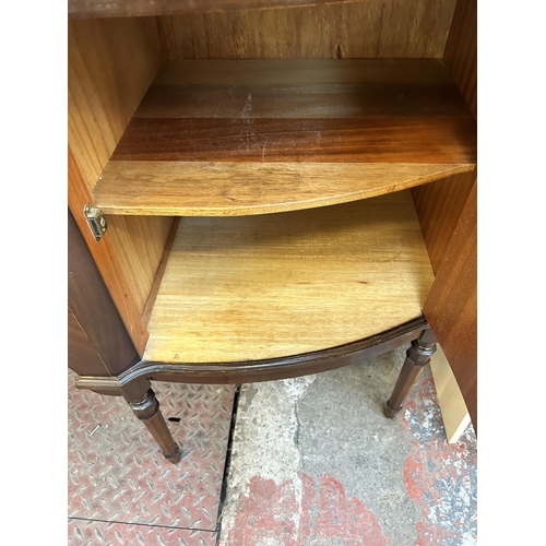 33 - A George IV style mahogany serpentine sideboard with three central drawers, two outer cupboard doors... 