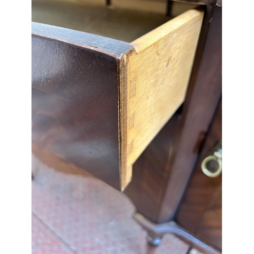 33 - A George IV style mahogany serpentine sideboard with three central drawers, two outer cupboard doors... 