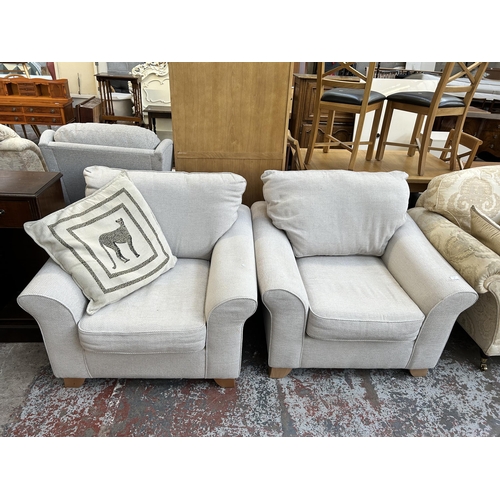 58 - A pair of modern grey fabric upholstered armchairs with beech supports