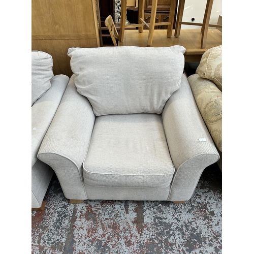 58 - A pair of modern grey fabric upholstered armchairs with beech supports