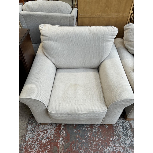 58 - A pair of modern grey fabric upholstered armchairs with beech supports