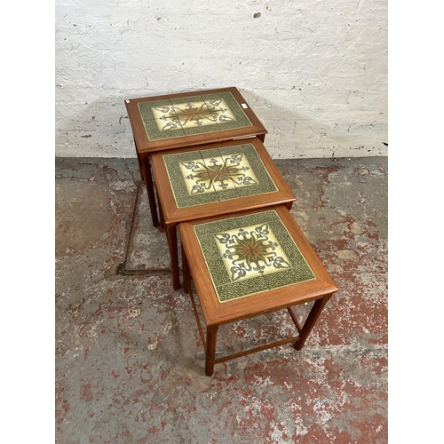 61 - A teak tiled top nest of three tables - approx. 49cm high x 56cm wide x 40cm deep