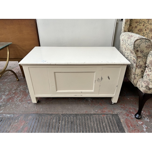 64 - A mid 20th century white painted blanket box with castors - approx. 48cm high x 89cm wide x 44cm dee... 