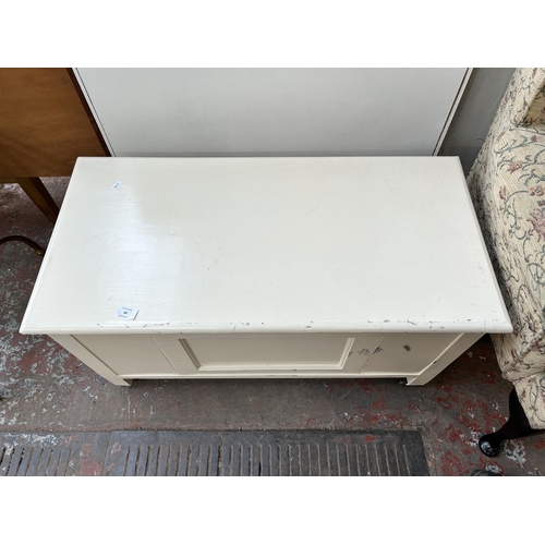 64 - A mid 20th century white painted blanket box with castors - approx. 48cm high x 89cm wide x 44cm dee... 