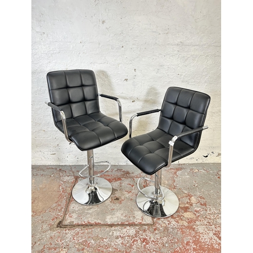 65 - A pair of modern black leatherette and chrome plated kitchen bar stools