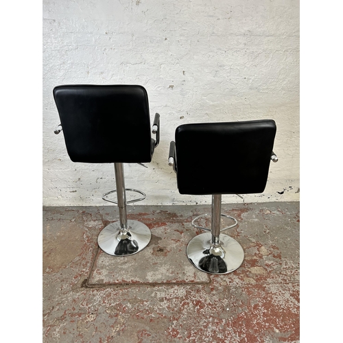 65 - A pair of modern black leatherette and chrome plated kitchen bar stools