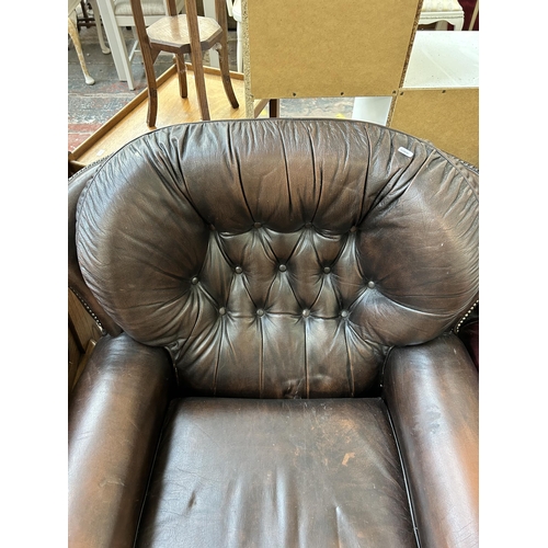 68 - A brown leather Chesterfield rocking armchair