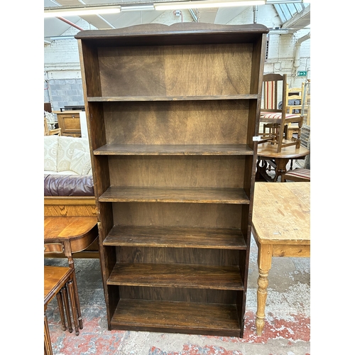 73 - A mid 20th century stained pine effect six tier freestanding open bookcase - approx. 187cm high x 93... 