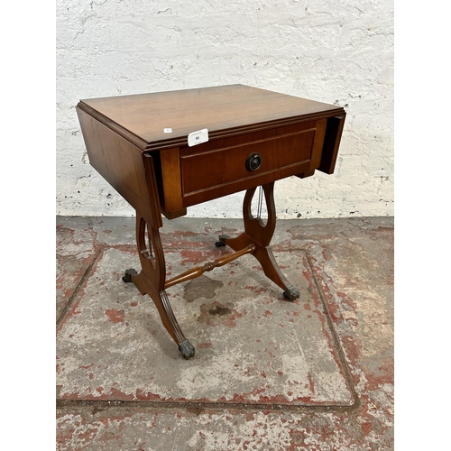 80 - A Regency style yew wood effect drop leaf lyre end side table with single drawer and brass lion paw ... 