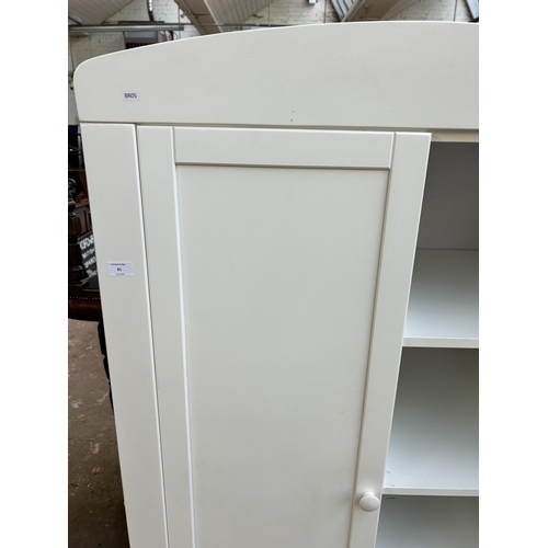 81 - A modern white painted child's wardrobe with four shelves, single door and lower drawer - approx. 17... 