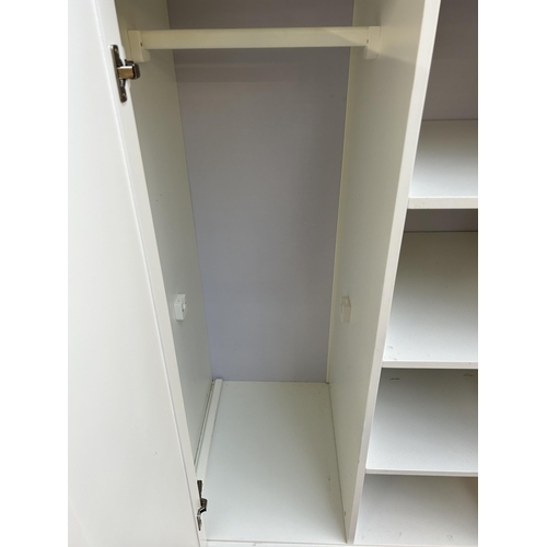 81 - A modern white painted child's wardrobe with four shelves, single door and lower drawer - approx. 17... 