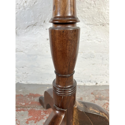 91 - A 19th century mahogany circular tripod occasional table - approx. 70cm high x 62cm diameter