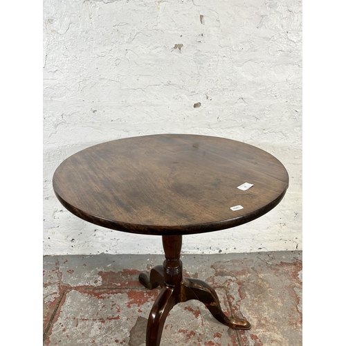 91 - A 19th century mahogany circular tripod occasional table - approx. 70cm high x 62cm diameter