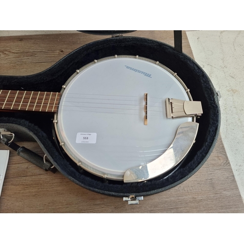 553 - A cased Musima five string banjo with tutorial book and accessories