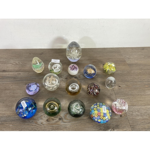 251 - Sixteen art glass paperweights to include Caithness Moon Crystal, India etc.