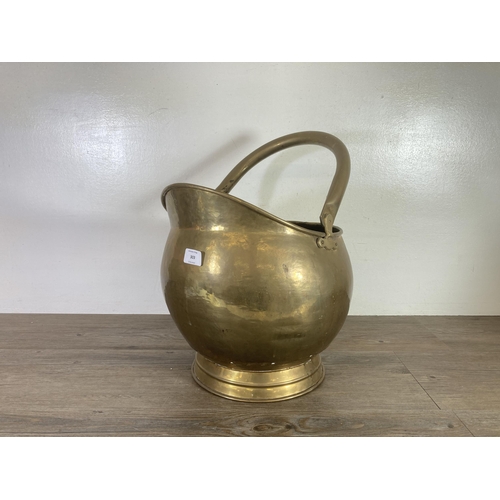 303 - A 19th century brass coal scuttle - approx. 34cm high